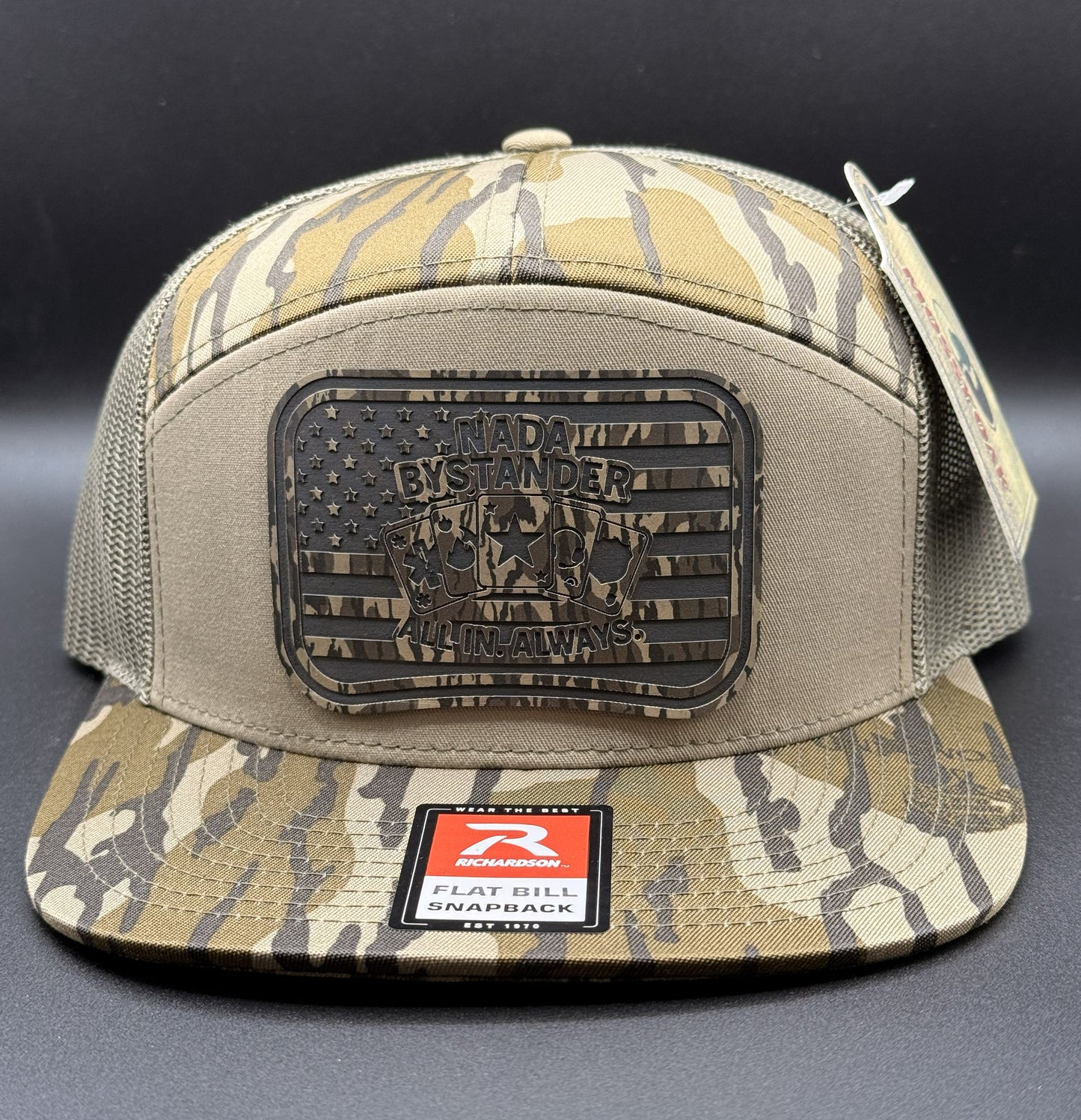 Camouflage cap with a patch and brand logo on a dark background