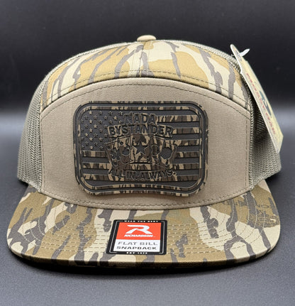 Camouflage cap with a patch and brand logo on a dark background
